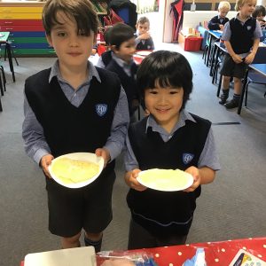 students holding pancakes