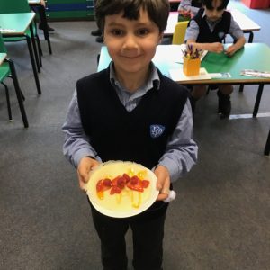 student holding a pancake